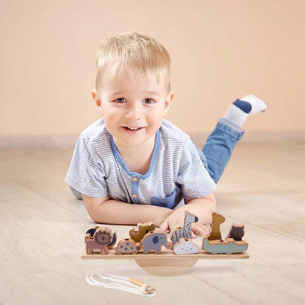 toddler with balance toy on floor