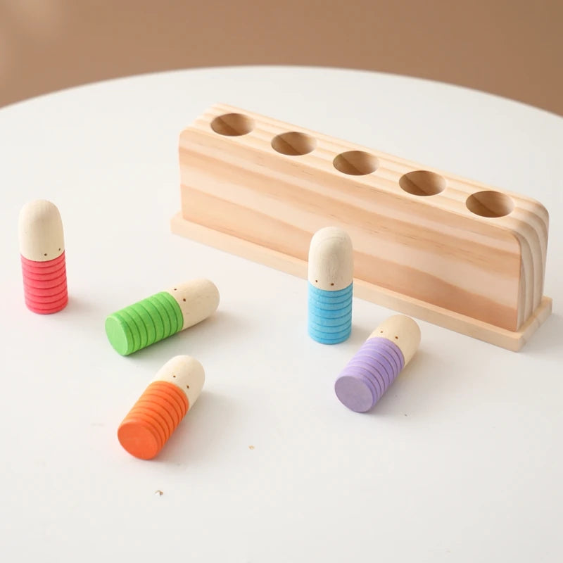 wooden pop up game with 5 colourful pop up figures lying beside the game