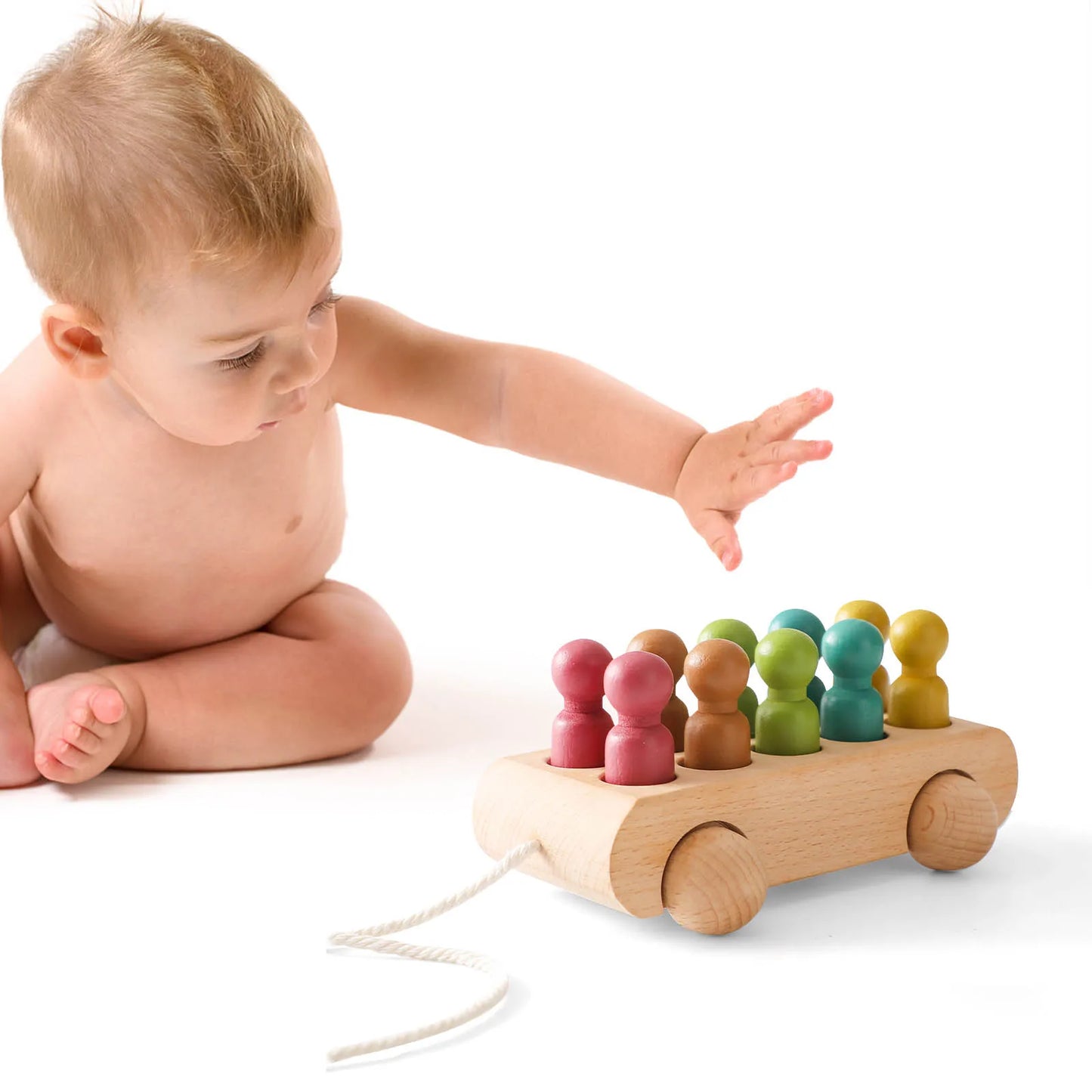 baby paying with Rainbow Riders Trolley 10 coloured wooden pegs in a car 